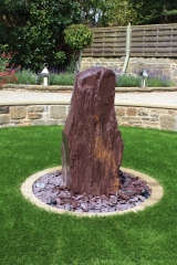 <h5>Plum slate Monolith</h5><p>One of our Plum slate monoliths with plum slate paddlestones at the base</p>